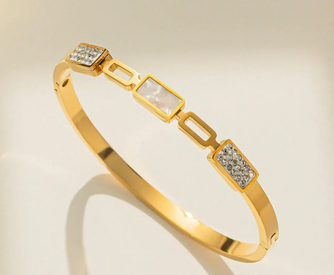 Gold bracelet with diamond and pearl accents illustrating what is anti-tarnish jewellery concept