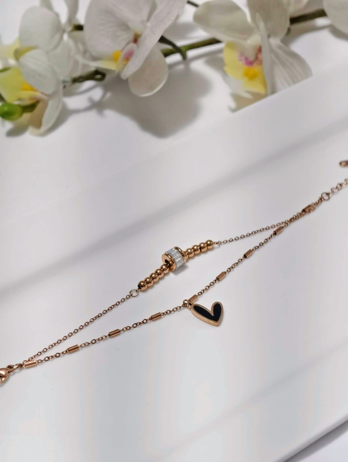 Affordable gold bracelet for girls with heart charm and bead details on delicate chain