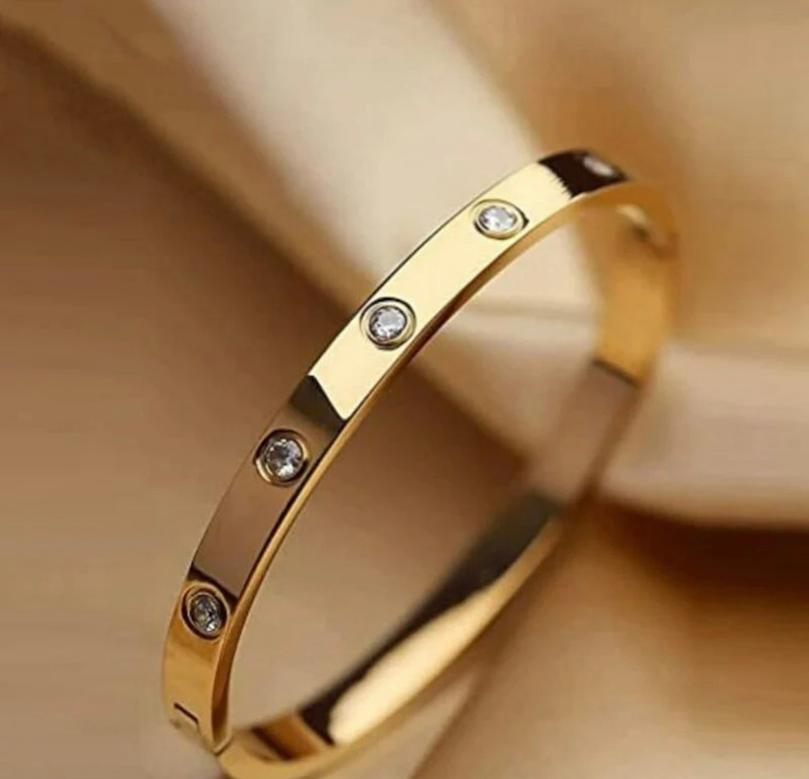 Gold bracelet with embedded clear gemstones by ELL DESIGNS elegant polished finish