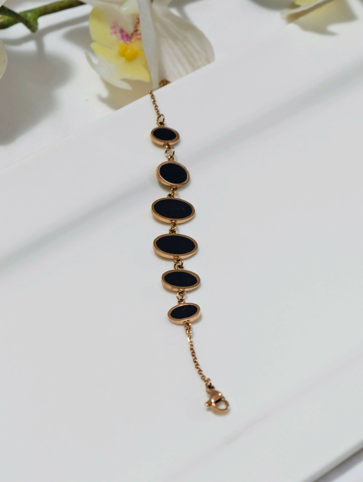 Elegant gold chain bracelet under 499 with black oval stones by ELL DESIGNS on white background