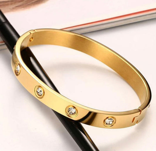 Gold-tone bangle bracelet with embedded clear crystals by ELL DESIGNS