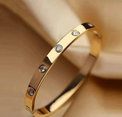 Gold bracelet with embedded clear gemstones by ELL DESIGNS elegant polished finish