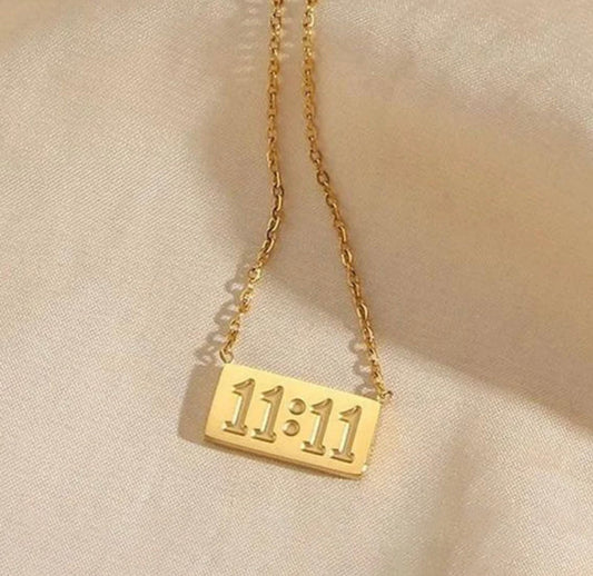 Gold necklace with rectangular pendant featuring embossed 11:11 number by ELL DESIGNS