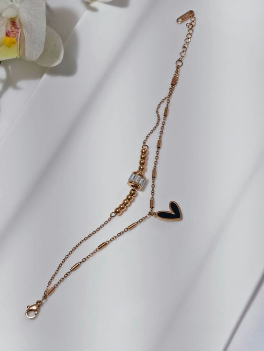 Affordable gold bracelet for girls featuring a delicate chain with heart charm and decorative beads